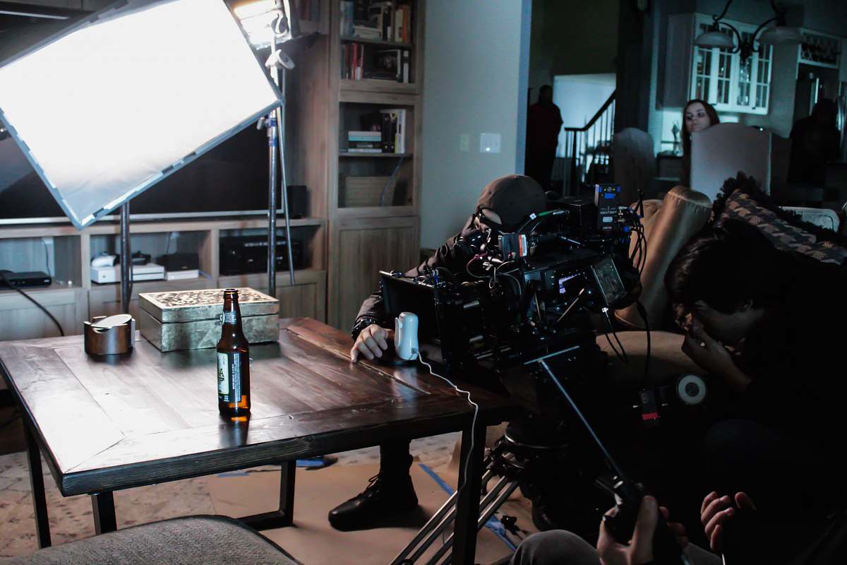 dining table man taking a video on table near studio lamp furniture